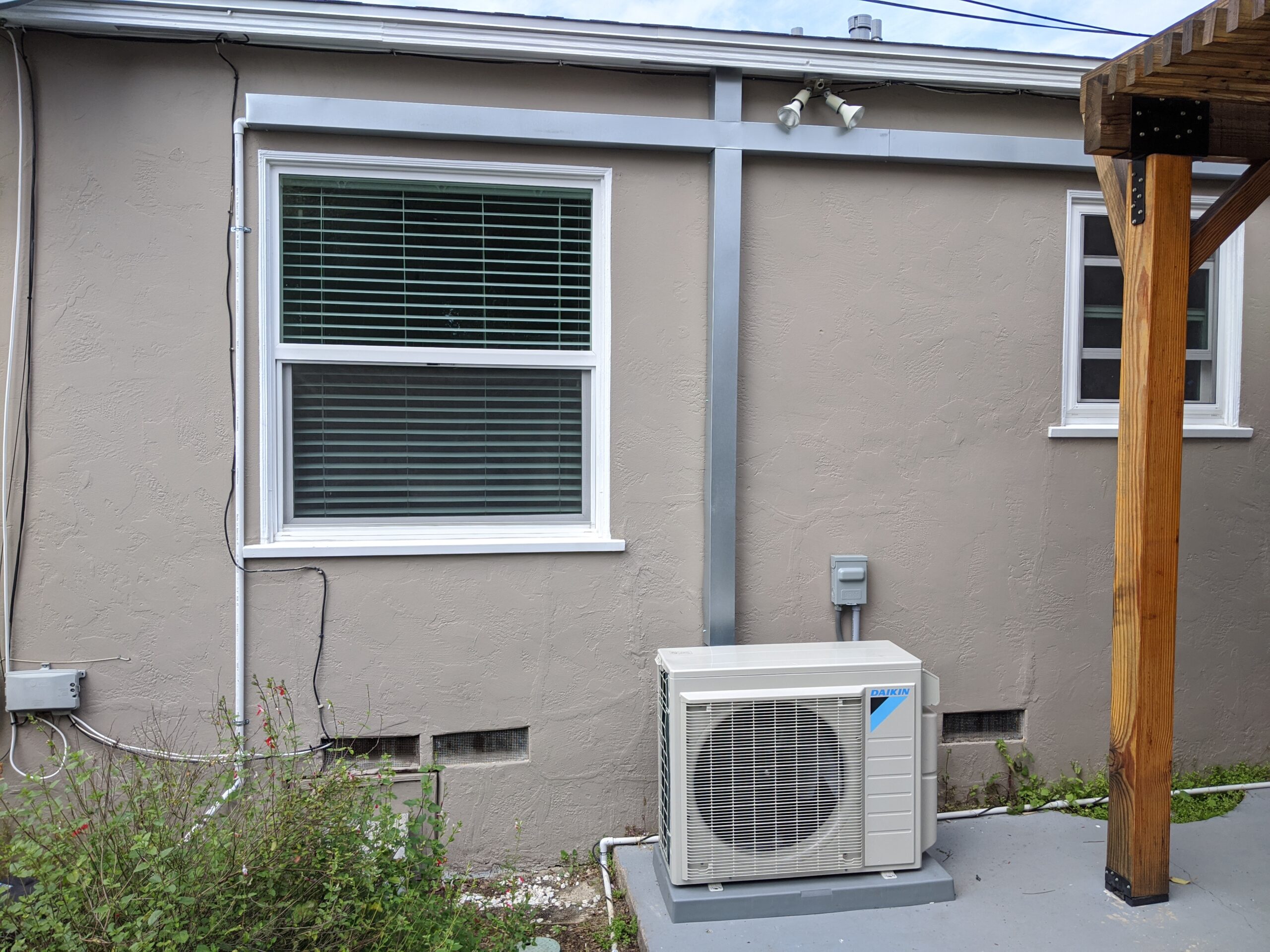 Daikin mini-split outdoor unit installed beside a home